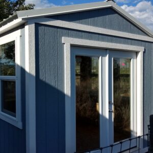 Ranch Style wood shed with french doors, windows, and painted